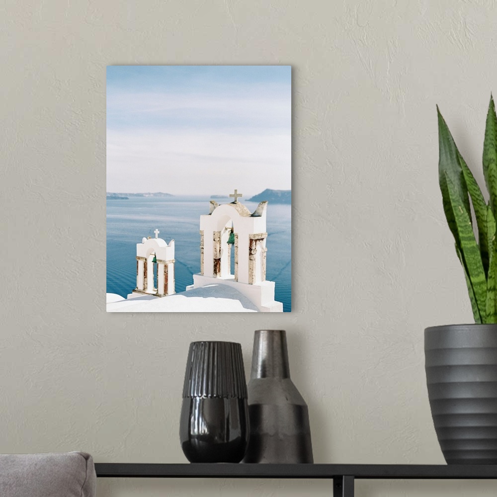 A modern room featuring Photograph of church bell towers overlooking the ocean in the Greek city of Oia, Santorini.