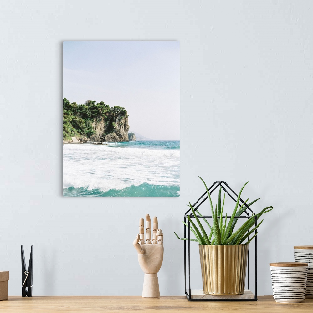 A bohemian room featuring Photograph of tall tree-topped cliffs above the ocean.