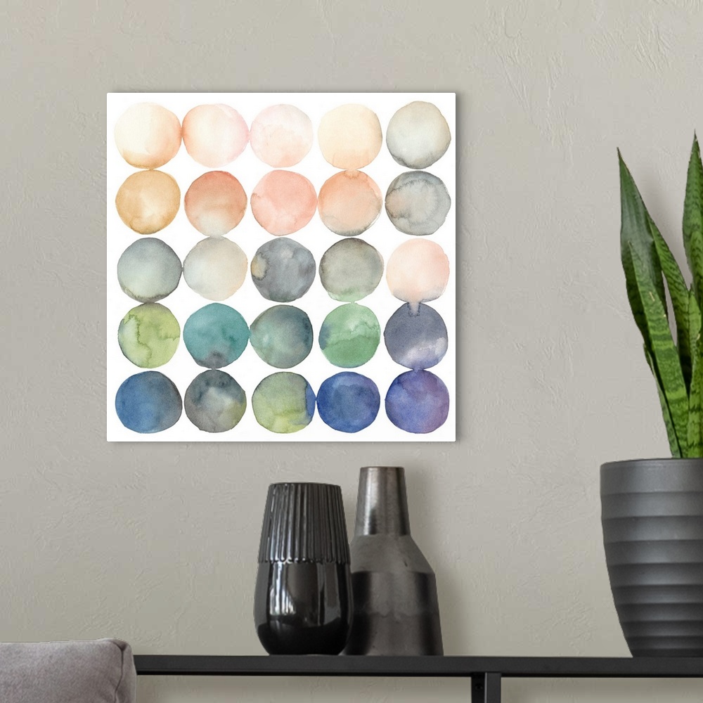 A modern room featuring Watercolor art print of twenty-five round shapes in peach and blue shades.