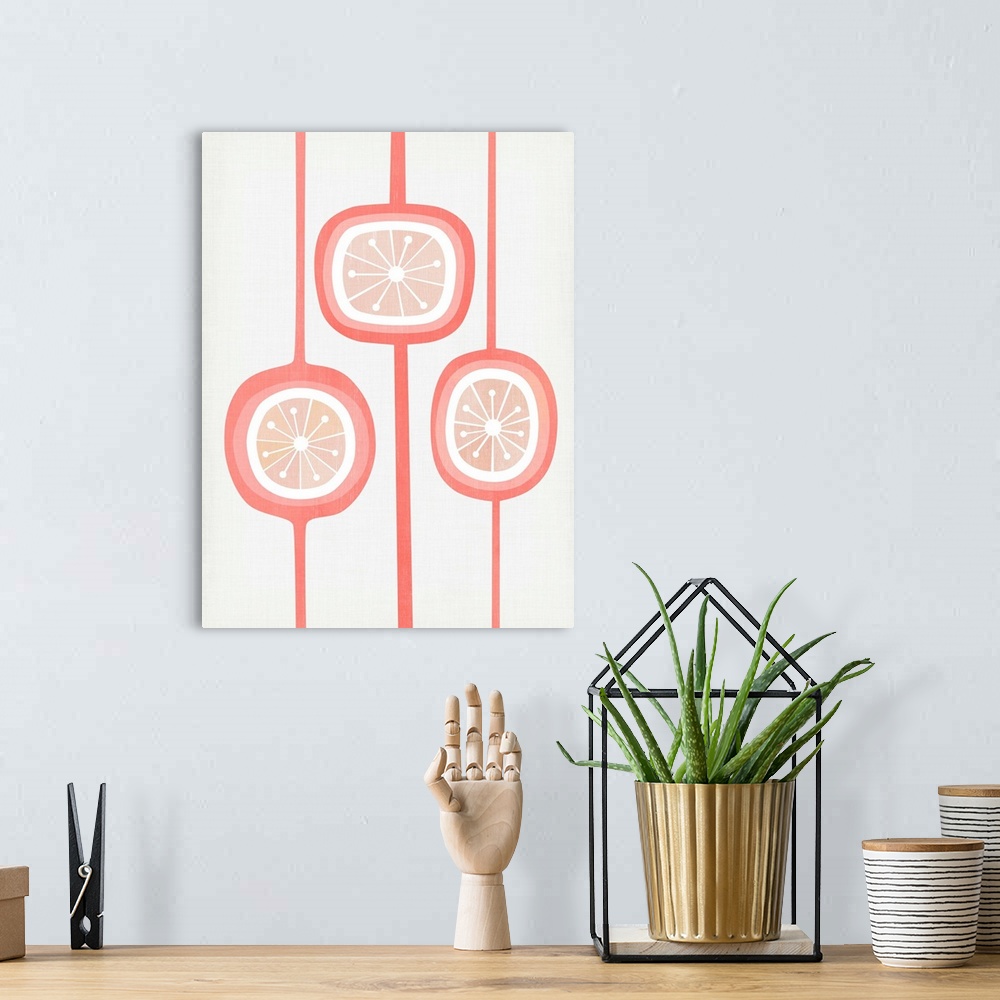 A bohemian room featuring Mid-century modern design of three seed pod shapes in shades of coral and blush against a dove gr...