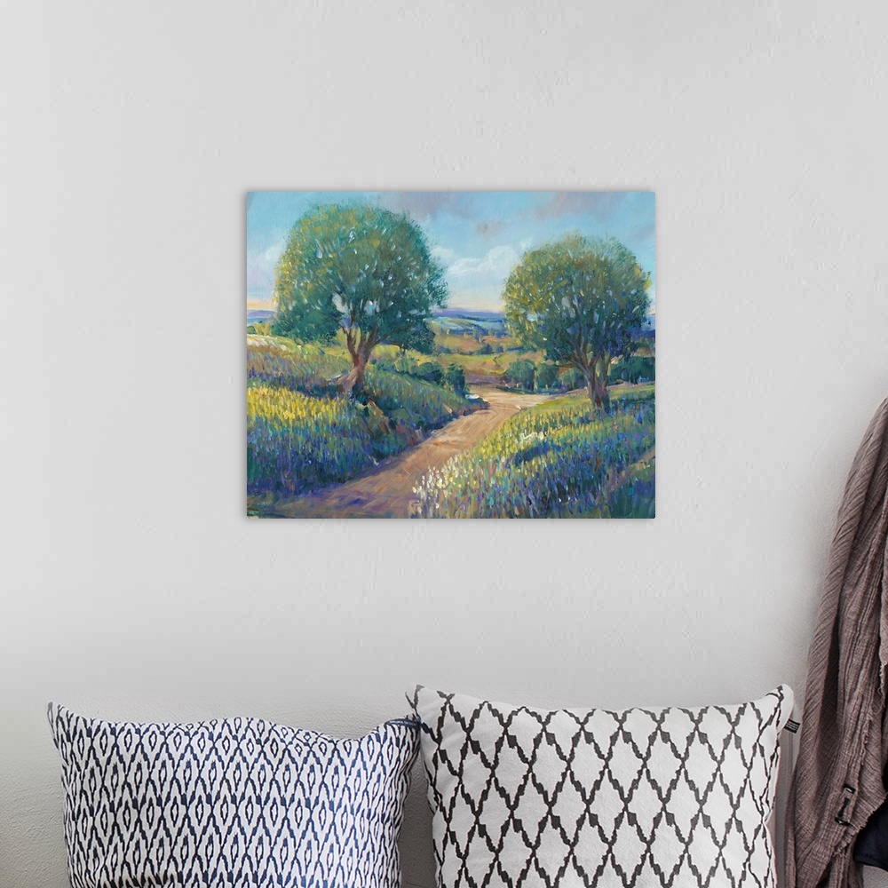 A bohemian room featuring Contemporary landscape painting of trees along a dirt path in the countryside.