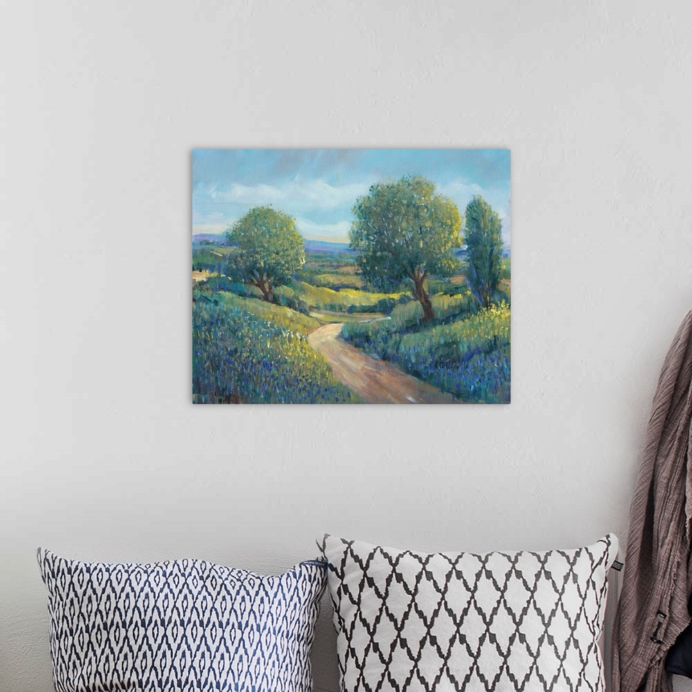 A bohemian room featuring Contemporary landscape painting of trees along a dirt path in the countryside.