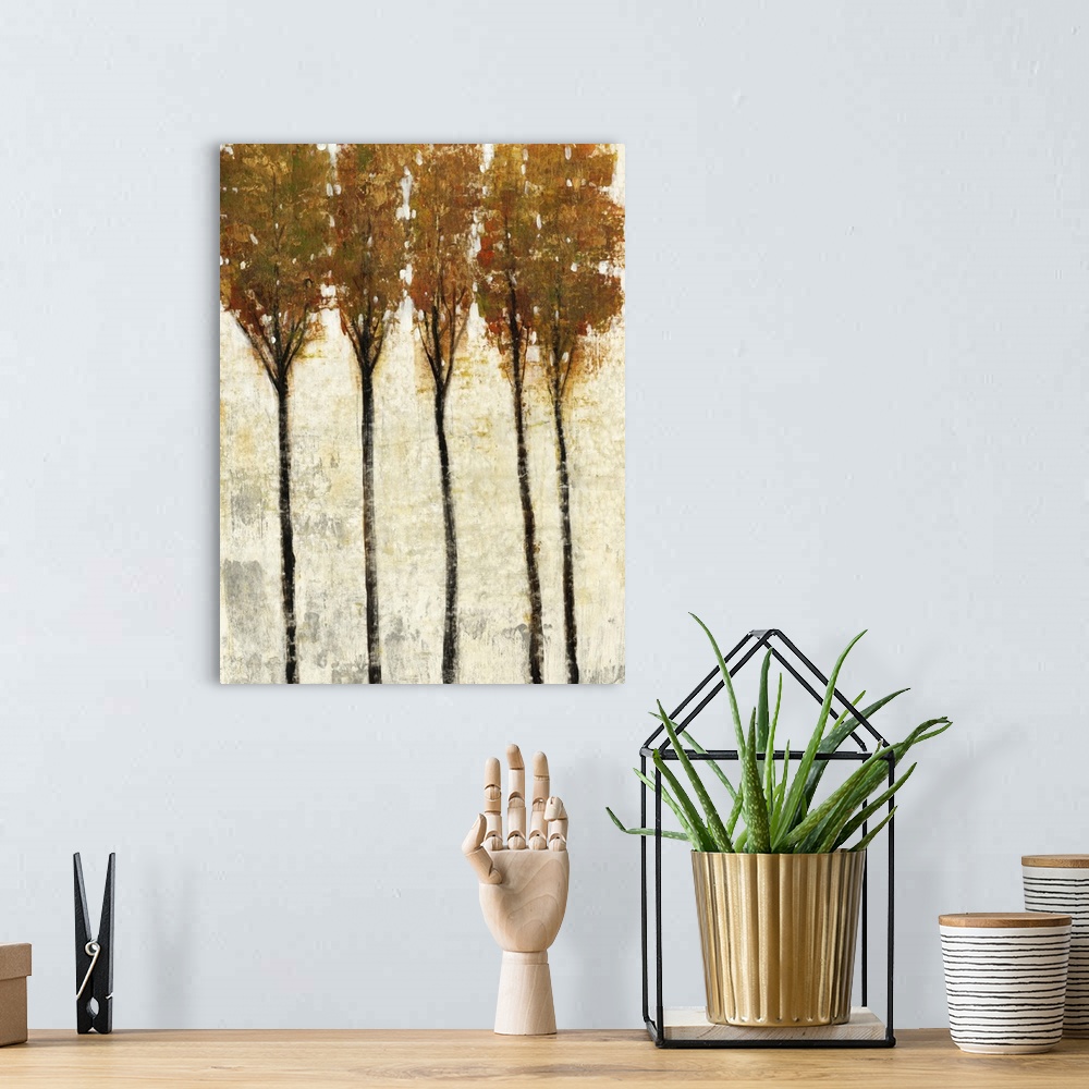A bohemian room featuring Contemporary painting of five thin trees with fall leaves.