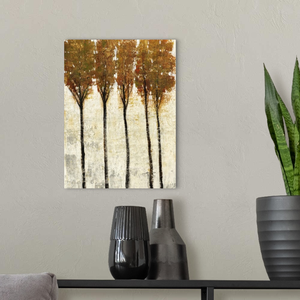 A modern room featuring Contemporary painting of five thin trees with fall leaves.