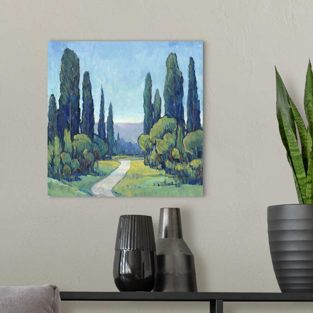 A modern room featuring Square painting of a green landscape filled with trees and a path leading to the background.