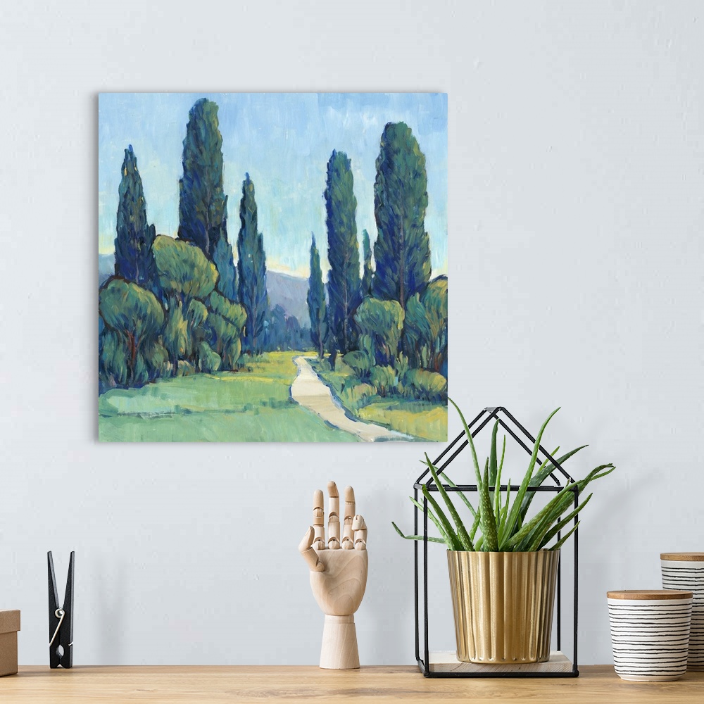 A bohemian room featuring Square painting of a green landscape filled with trees and a path leading to the background.
