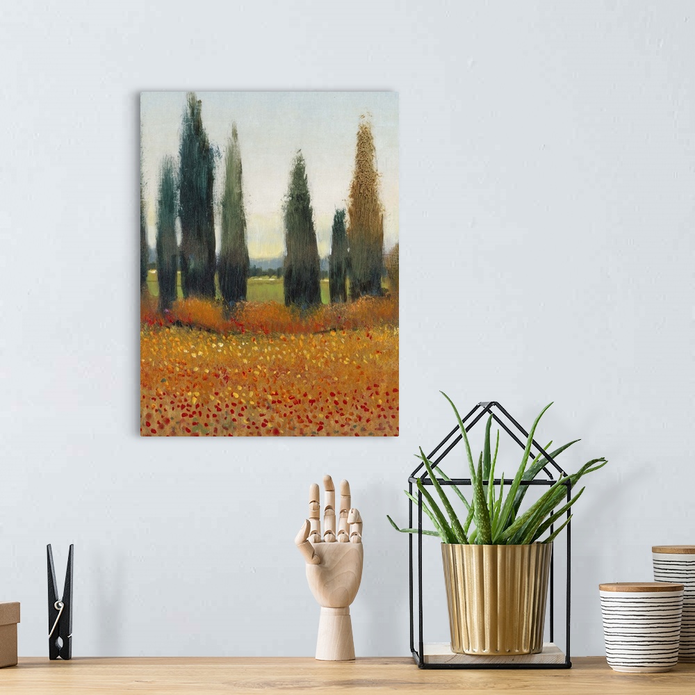 A bohemian room featuring Painting of a row of cypress trees in the Italian countryside.