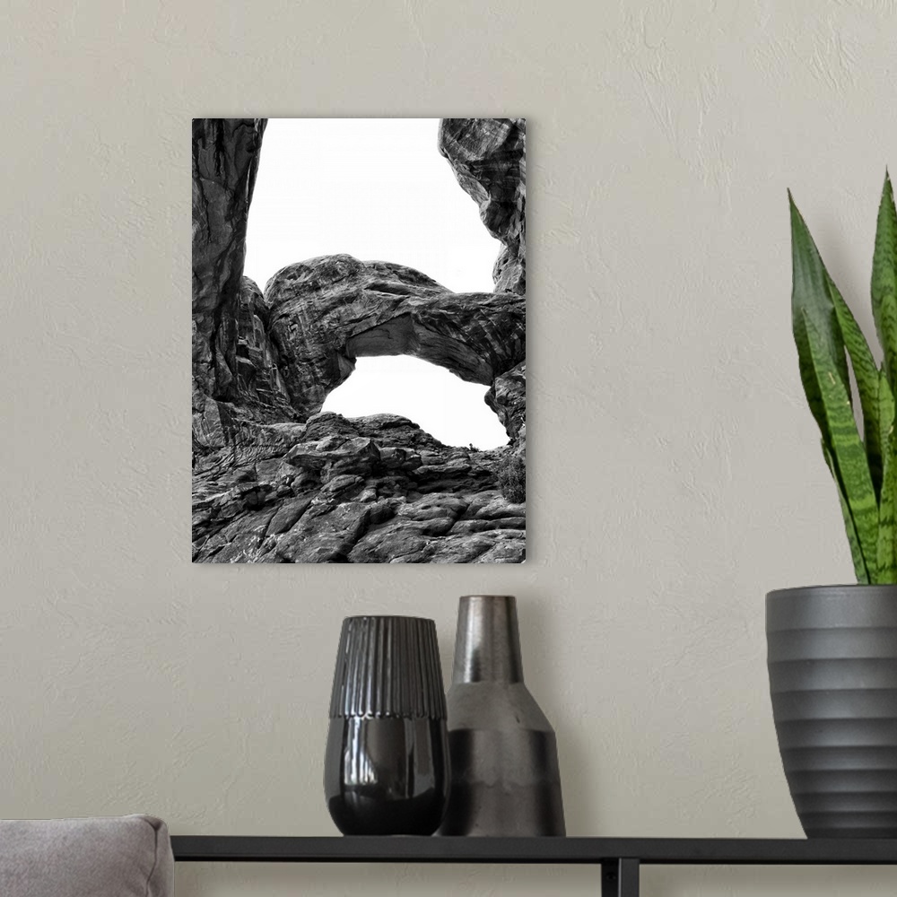 A modern room featuring Black and white photograph of Arches National Park.