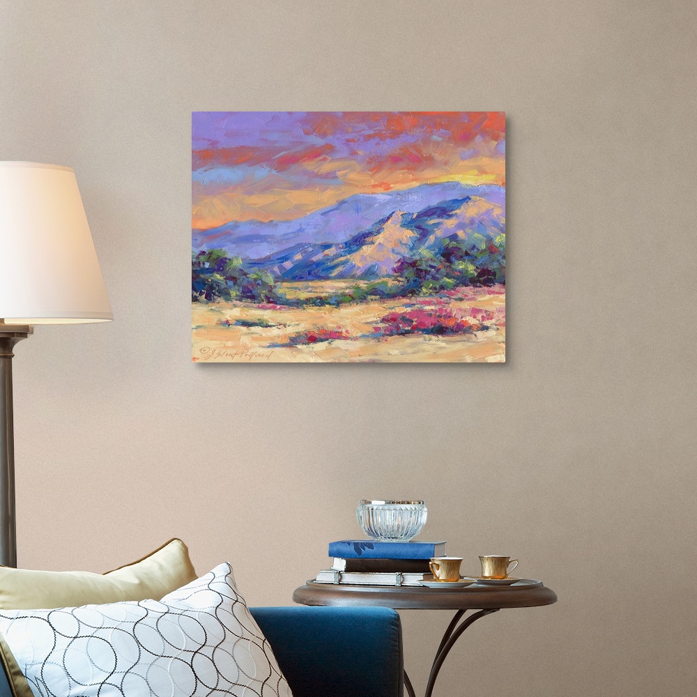 A traditional room featuring Contemporary vibrant landscape painting of a desert mountain sunset.