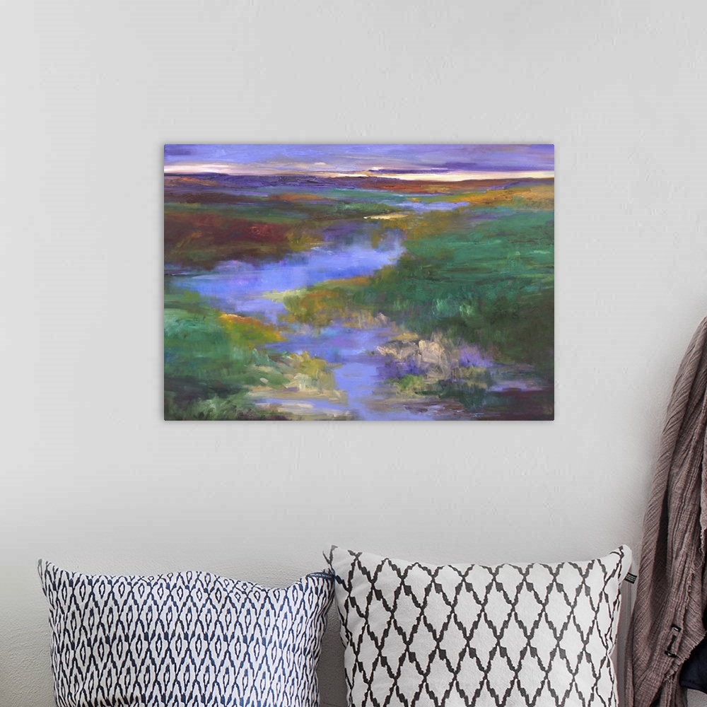A bohemian room featuring Contemporary landscape artwork of a river running through a marshy countryside.