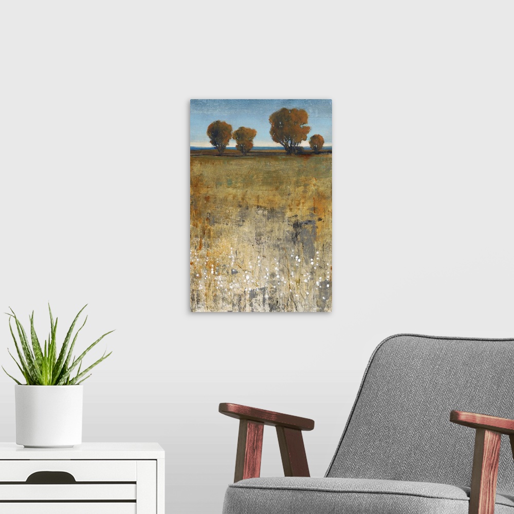 A modern room featuring Contemporary painting of a field with trees in the distance.