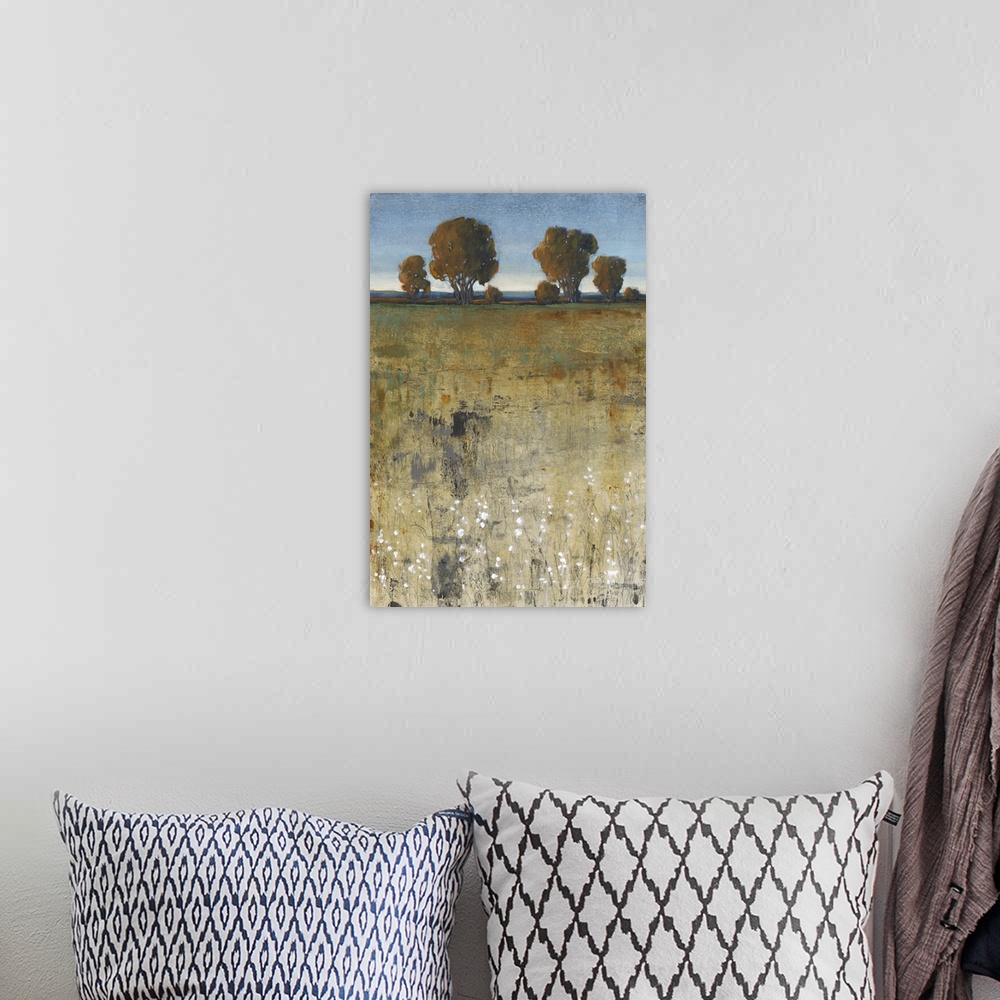 A bohemian room featuring Contemporary painting of a field with trees in the distance.
