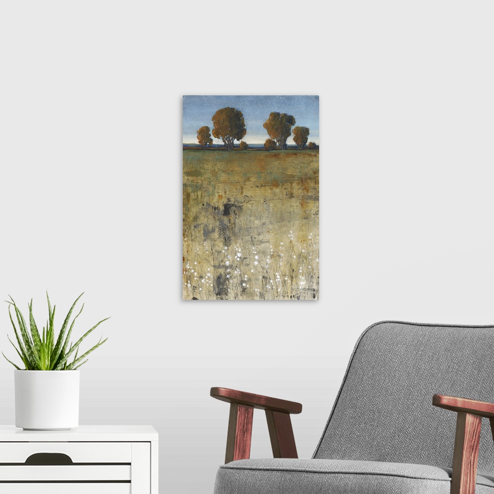 A modern room featuring Contemporary painting of a field with trees in the distance.
