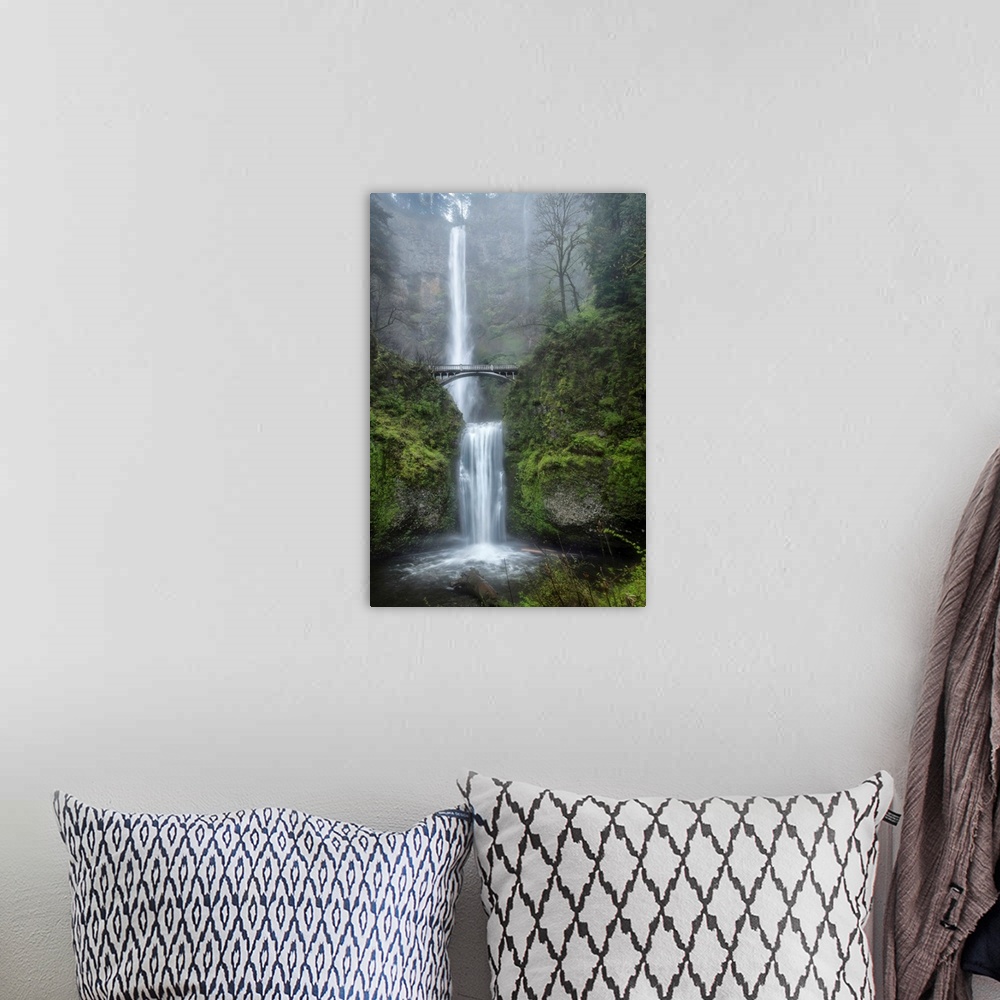 A bohemian room featuring Photograph of a serene waterfall among vibrant greenery vegetation in the mist.
