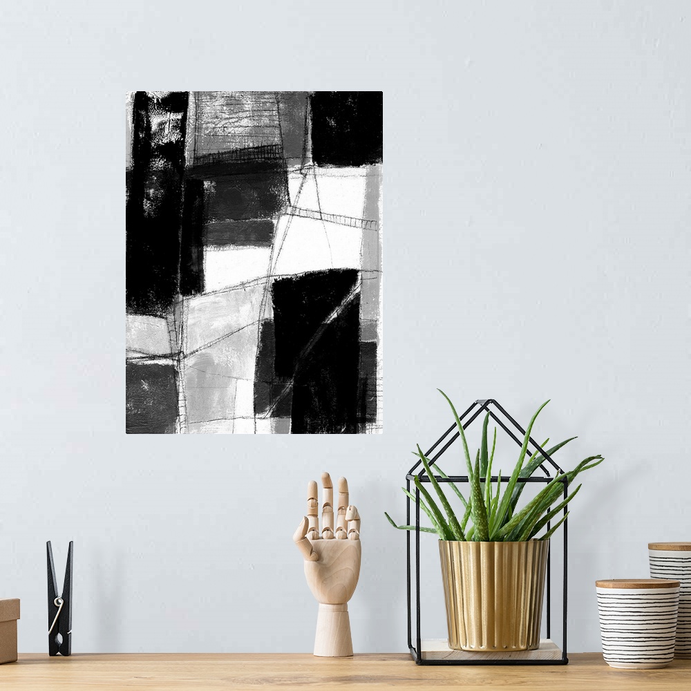 A bohemian room featuring Contemporary abstract painting made of white and black blocks.