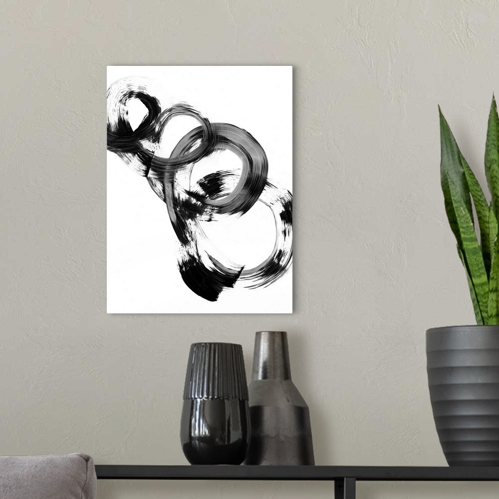 A modern room featuring Contemporary abstract painting of interlocking circular shapes in black and white.