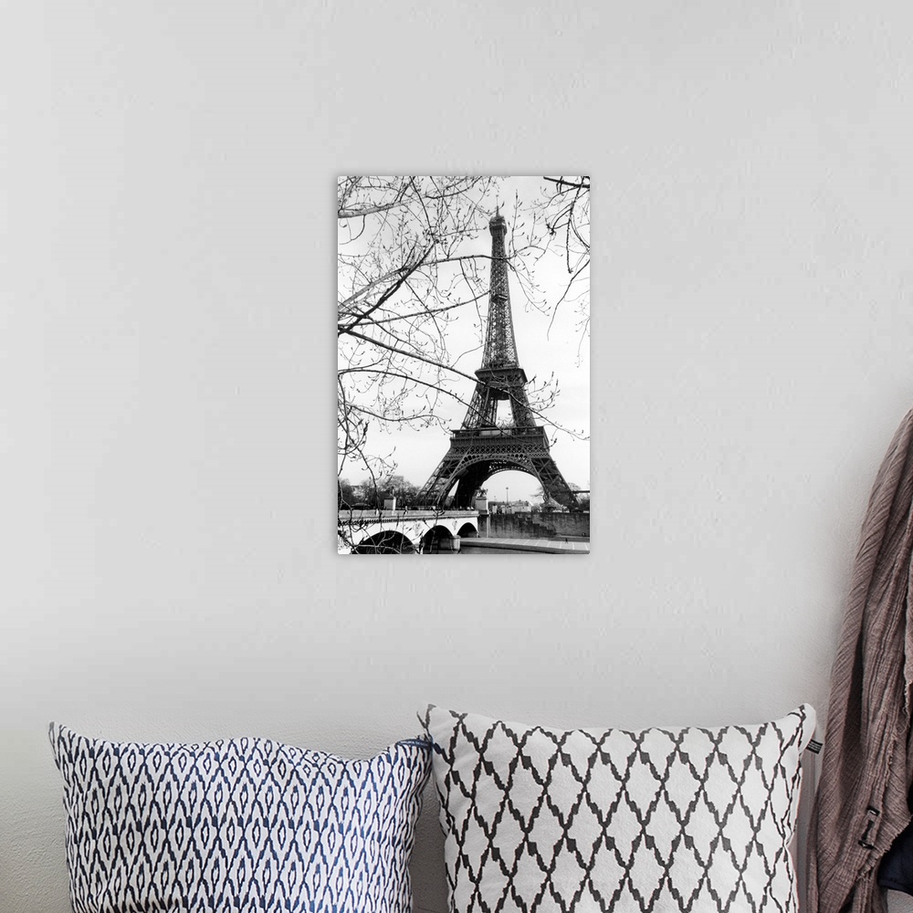 A bohemian room featuring View of the Eiffel Tower through the budding tree branches at the base of the Seine River.