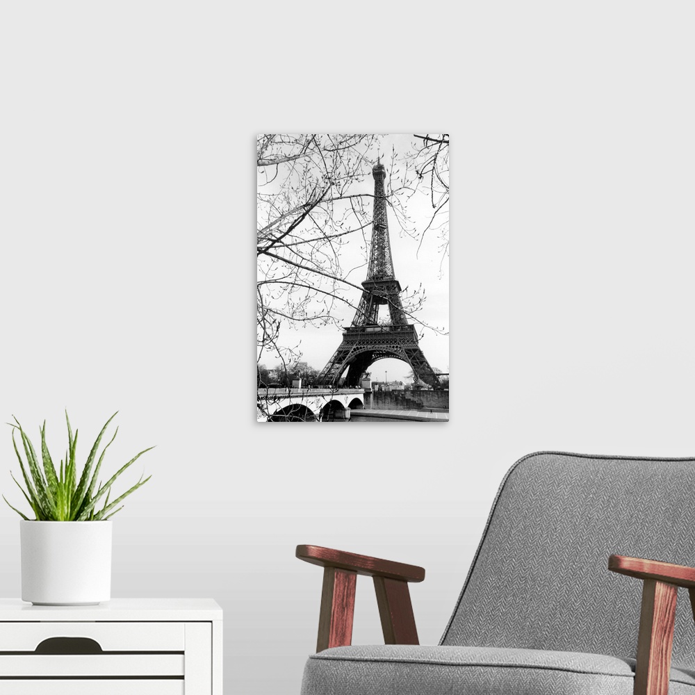 A modern room featuring View of the Eiffel Tower through the budding tree branches at the base of the Seine River.