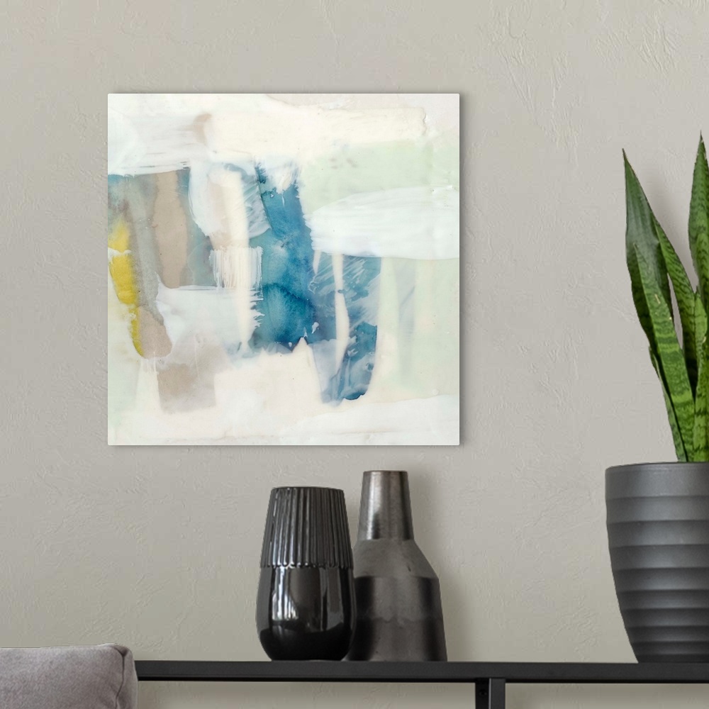 A modern room featuring Pale colored abstract artwork in shades of yellow and mint green.