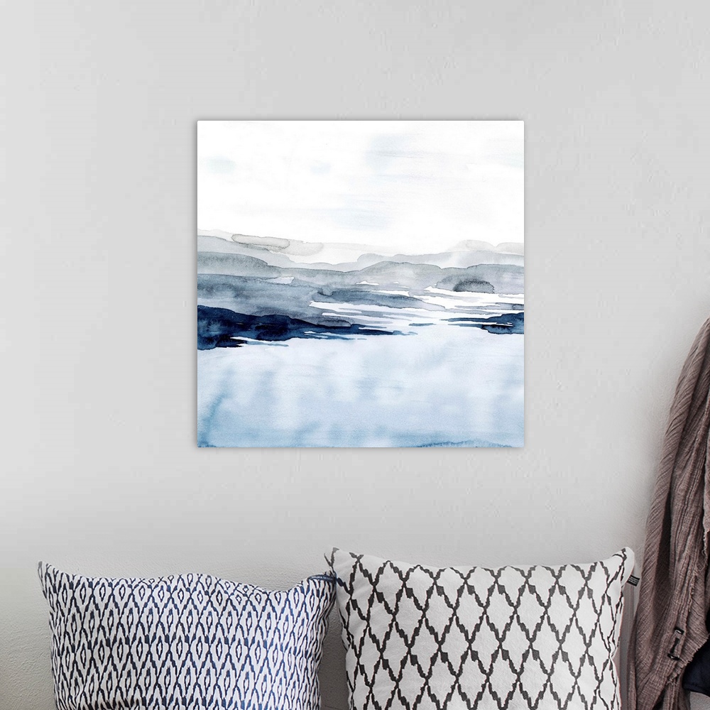 A bohemian room featuring Watercolor landscape art of a pale blue ocean under a light grey sky.