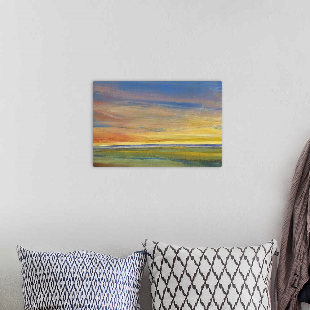 A bohemian room featuring Contemporary painting of a landscape at sunset, with colorful clouds.
