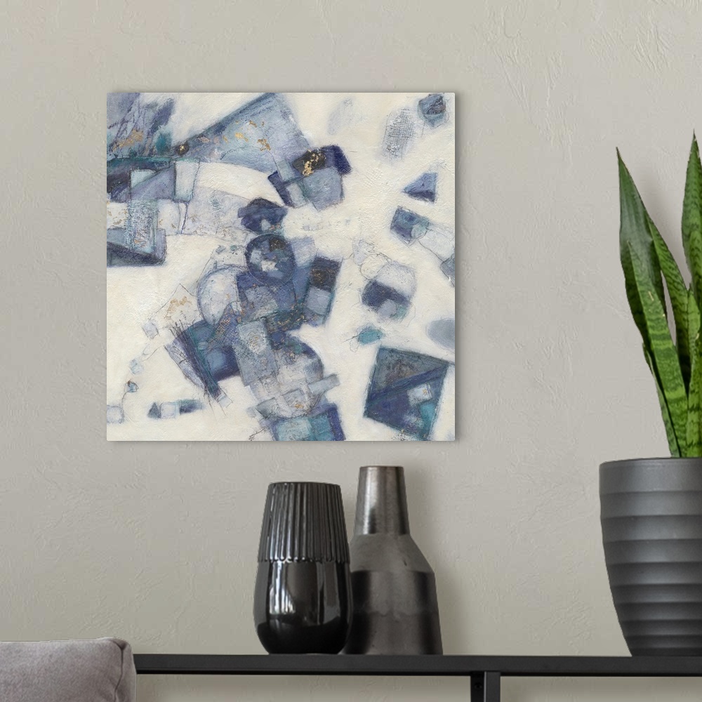 A modern room featuring Square abstract painting with shapes layered together in shades of blue on a white textured backg...