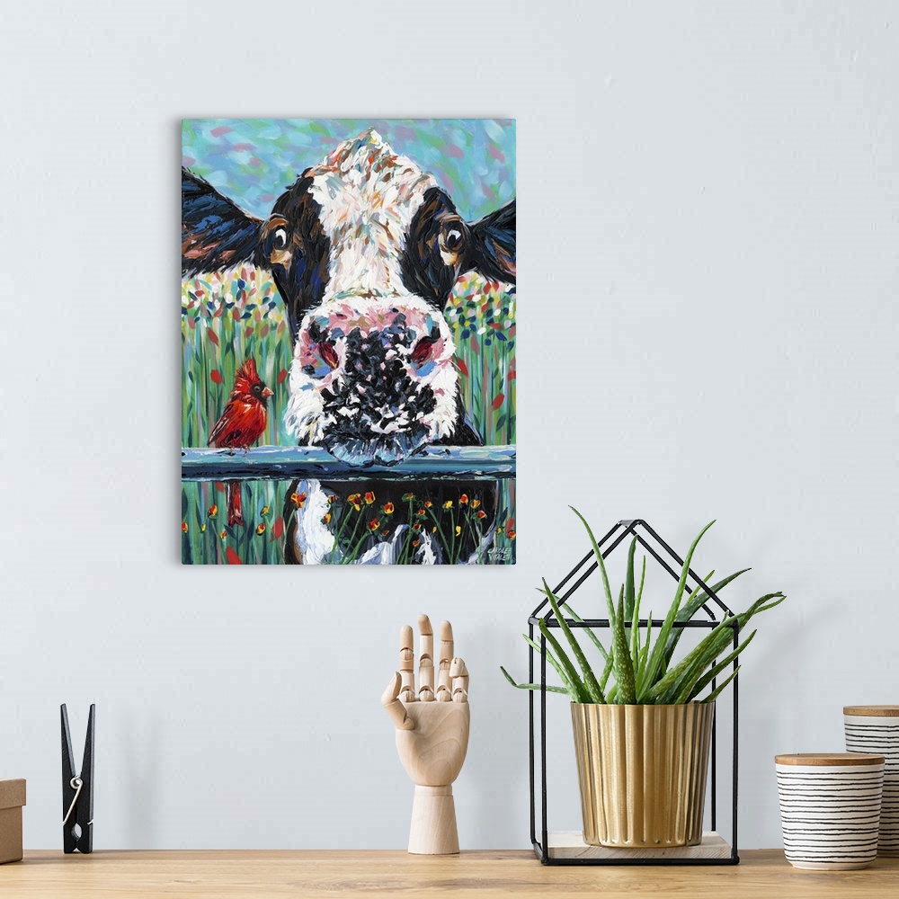 A bohemian room featuring Contemporary painting of a black and white cow resting its head on a blue fence.