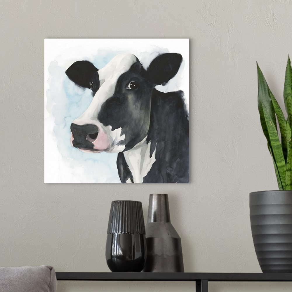 A modern room featuring A watercolor portrait of a black and white cow with pink and blue accents.