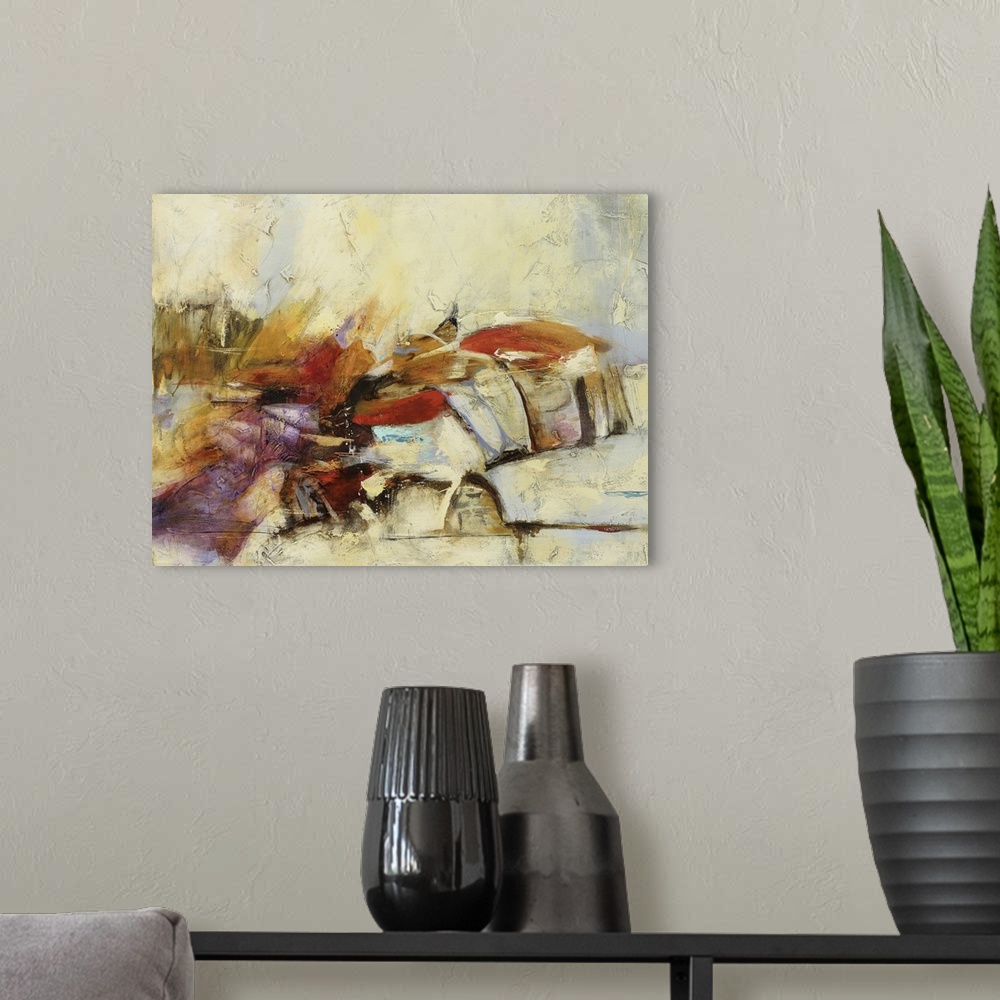 A modern room featuring Horizontal abstract painting in tones of yellow, orange and red with textured cream accents.