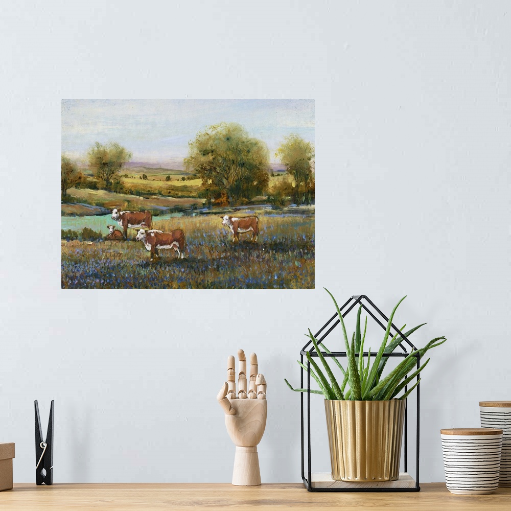 A bohemian room featuring Contemporary artwork of a calm countryside filled with grazing cows and blue flowers created with...