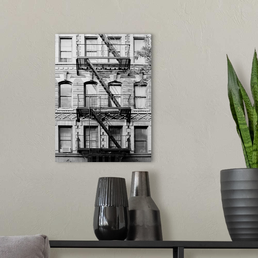 A modern room featuring Black and white architectural photo of a New York building's fire escape.