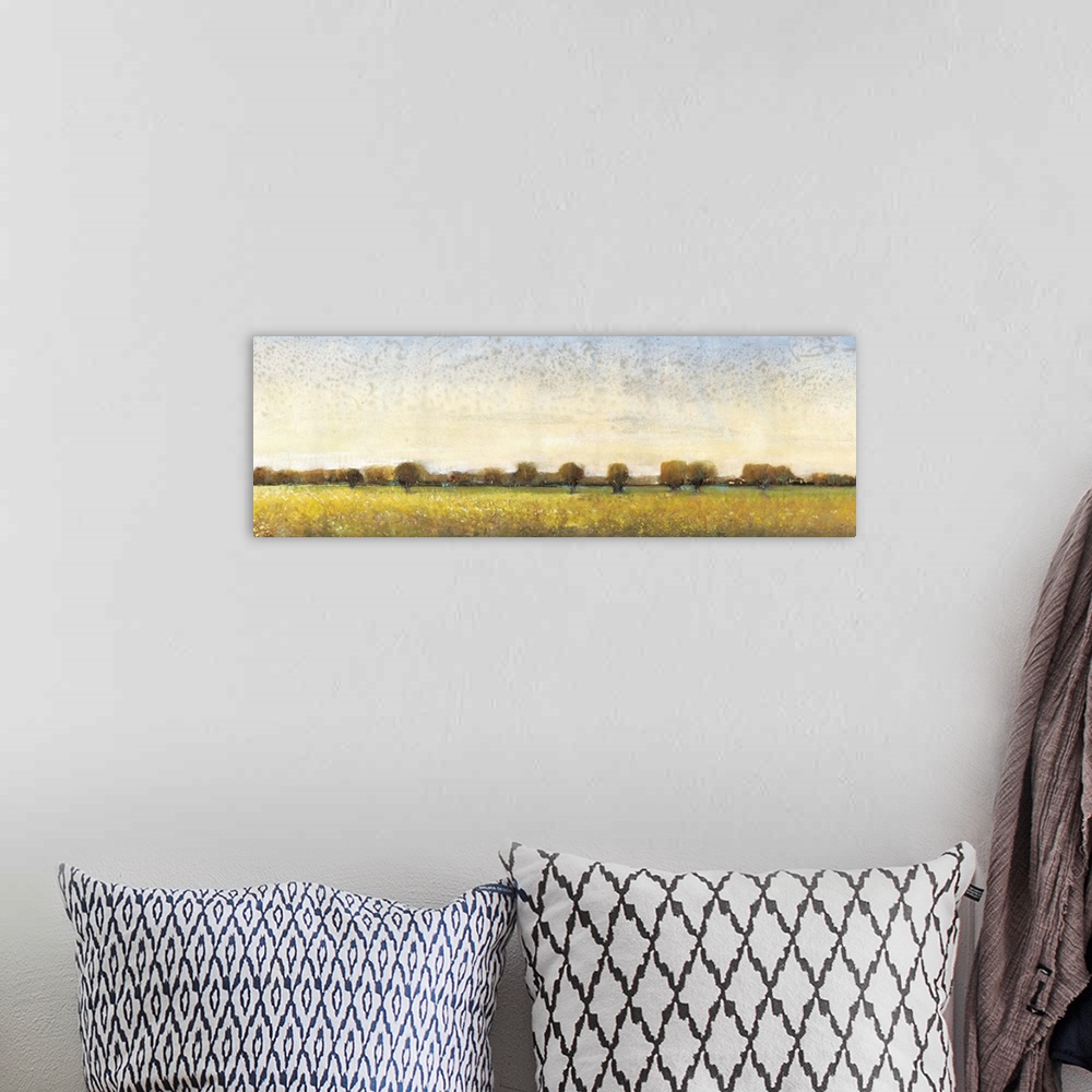 A bohemian room featuring Contemporary painting of a meadow with trees in the distance.