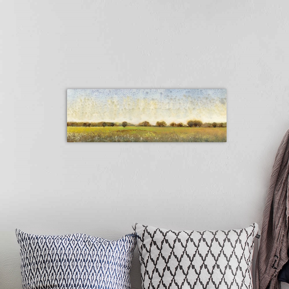 A bohemian room featuring Contemporary painting of a meadow with trees in the distance.