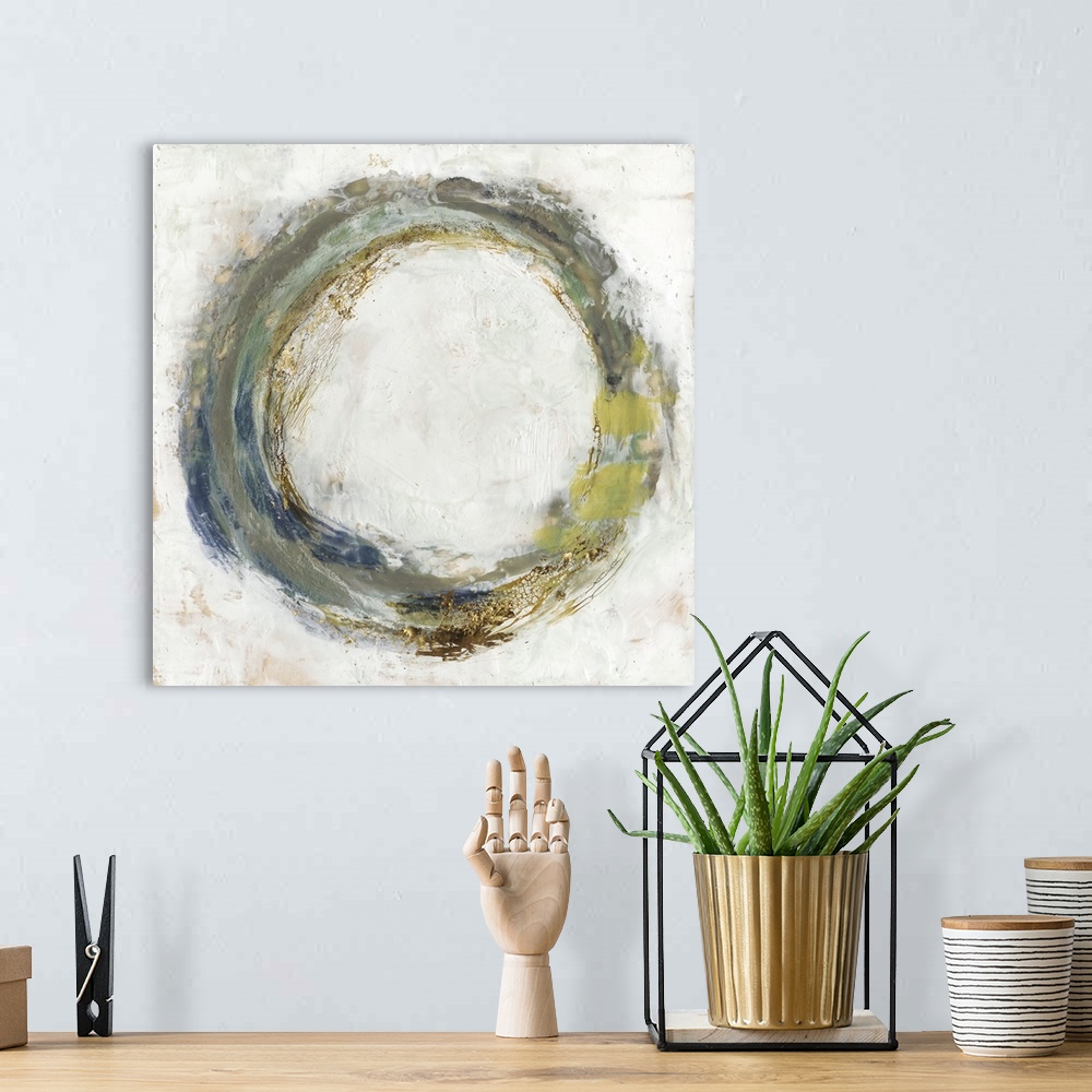 A bohemian room featuring Abstract artwork of a circular shape in green and blue, with a gold leaf effect.