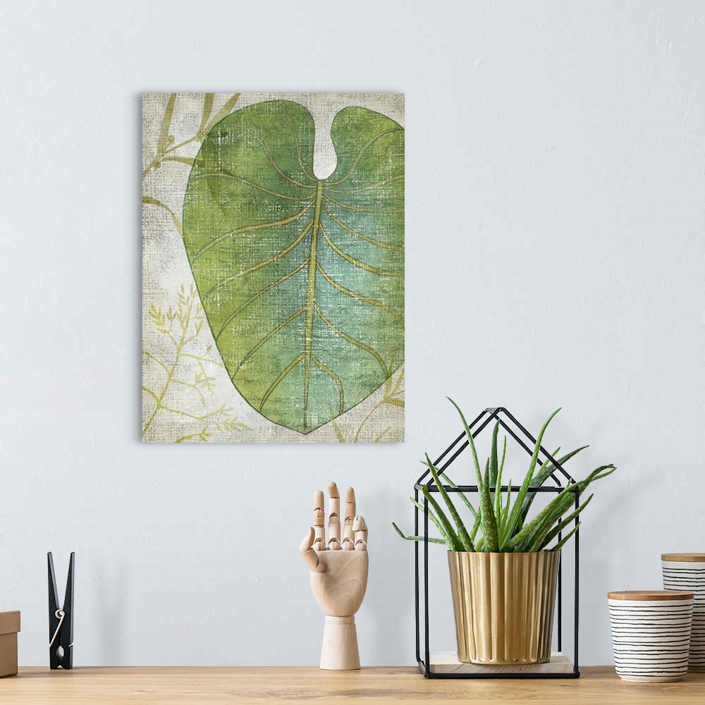 A bohemian room featuring Vertical decor with an illustrated tropical leaf on a textured neutral colored background.