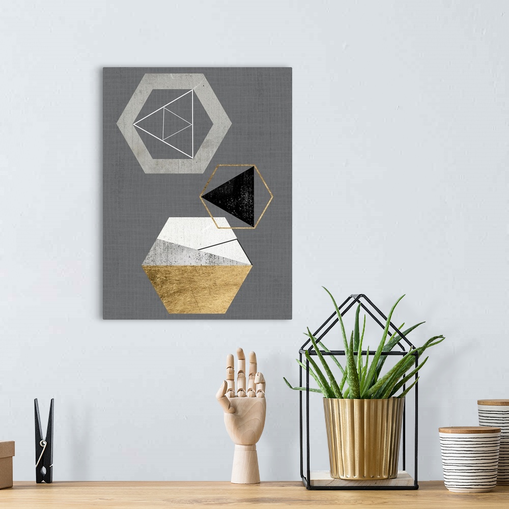 A bohemian room featuring Abstract geometric artwork of triangular and hexagonal shapes in grey and gold.