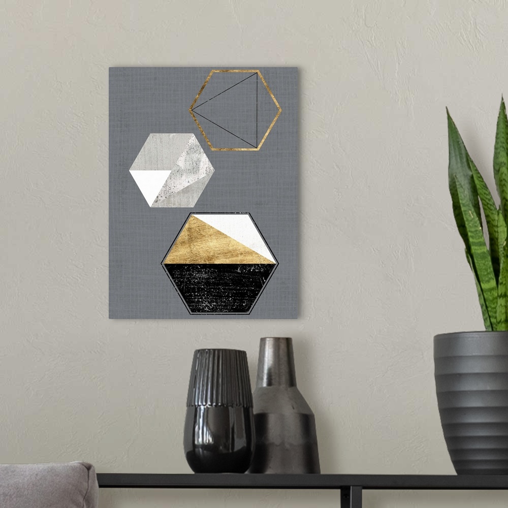 A modern room featuring Abstract geometric artwork of triangular and hexagonal shapes in grey and gold.