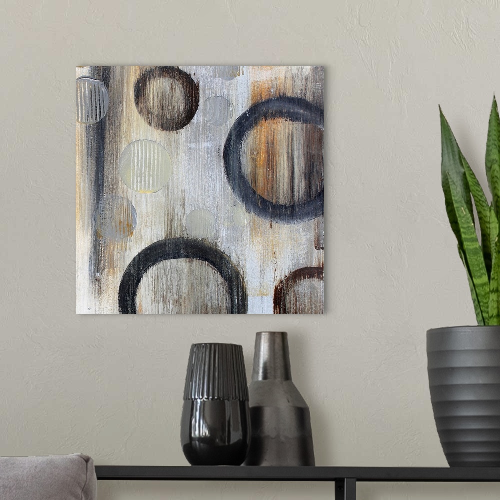 A modern room featuring Abstract artwork of circle floating against a gray background with an overall grungy look.