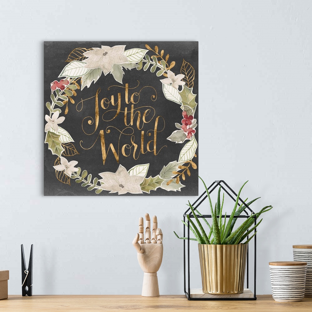 A bohemian room featuring "Joy To The World" in gold surrounded by a wreath of muted green shades with gold accents.