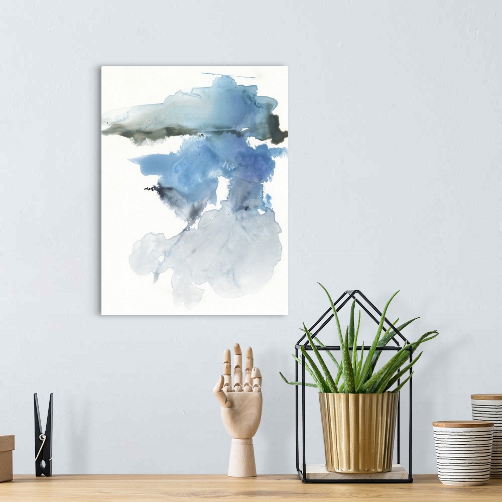 A bohemian room featuring A vertical abstract painting in blurred, blended colors of blur and gray on a white background.