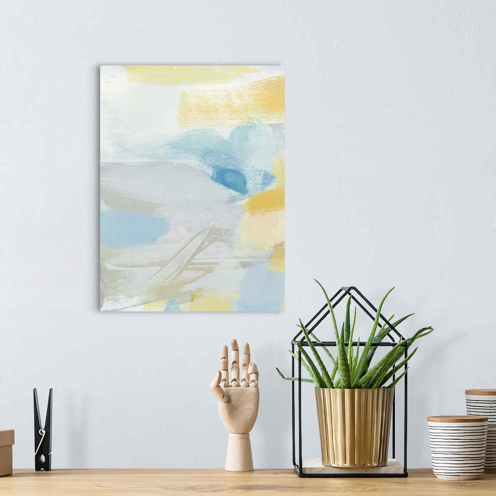 A bohemian room featuring Contemporary abstract art using soft pale yellows and blues mixing together to create depth.