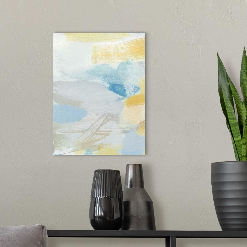 A modern room featuring Contemporary abstract art using soft pale yellows and blues mixing together to create depth.