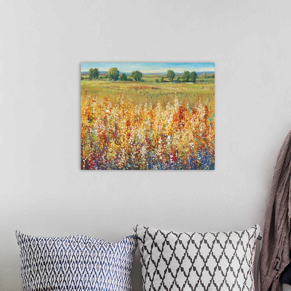 A bohemian room featuring Contemporary artwork of a field of yellow and red flowers with a green meadow in the distance.