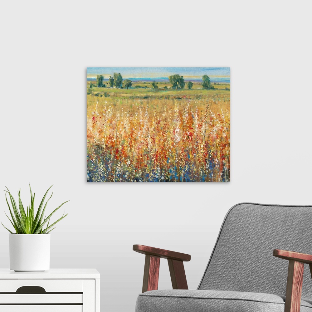 A modern room featuring Contemporary artwork of a field of yellow and red flowers with a green meadow in the distance.