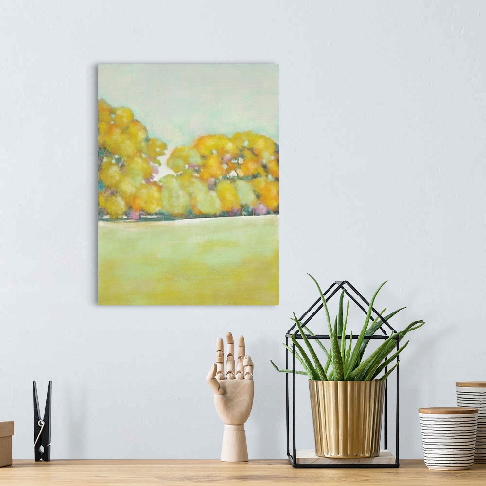 A bohemian room featuring Contemporary landscape art print of yellow trees at the edge of an open field.