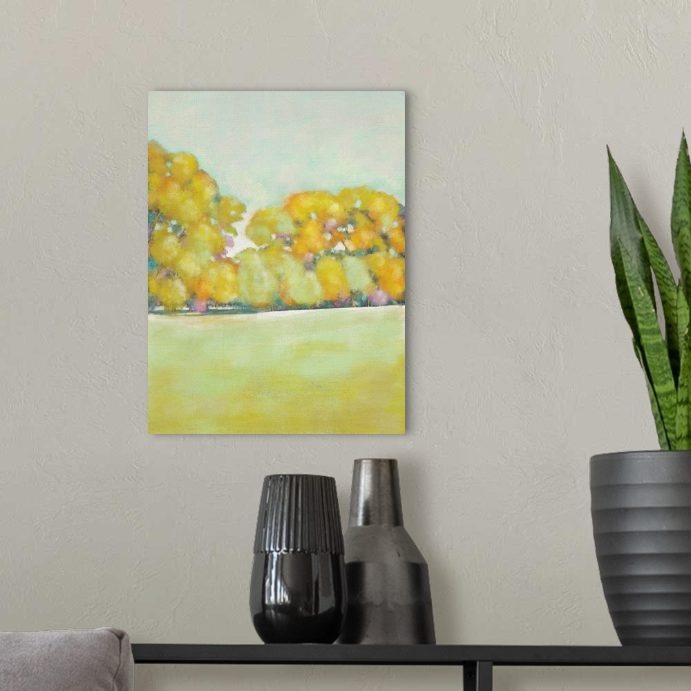 A modern room featuring Contemporary landscape art print of yellow trees at the edge of an open field.