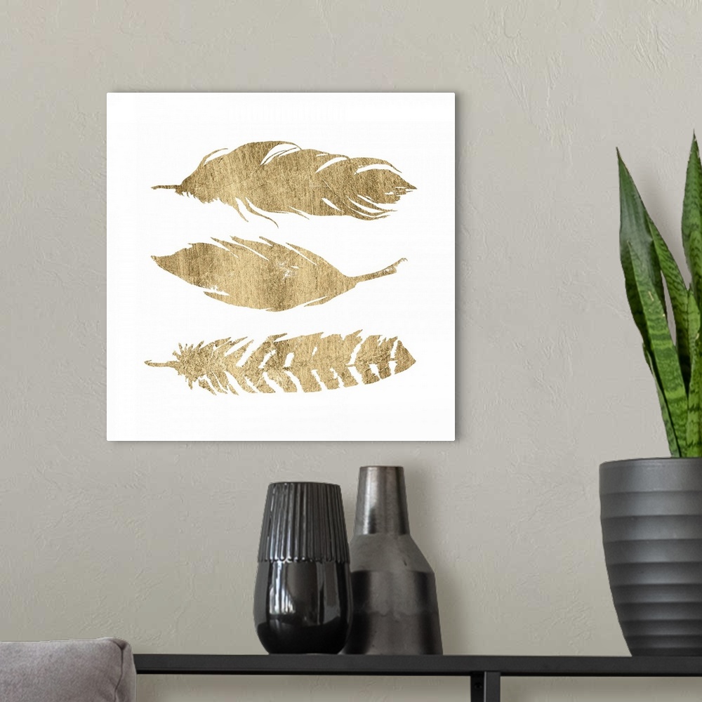 A modern room featuring Three golden feathers on white.