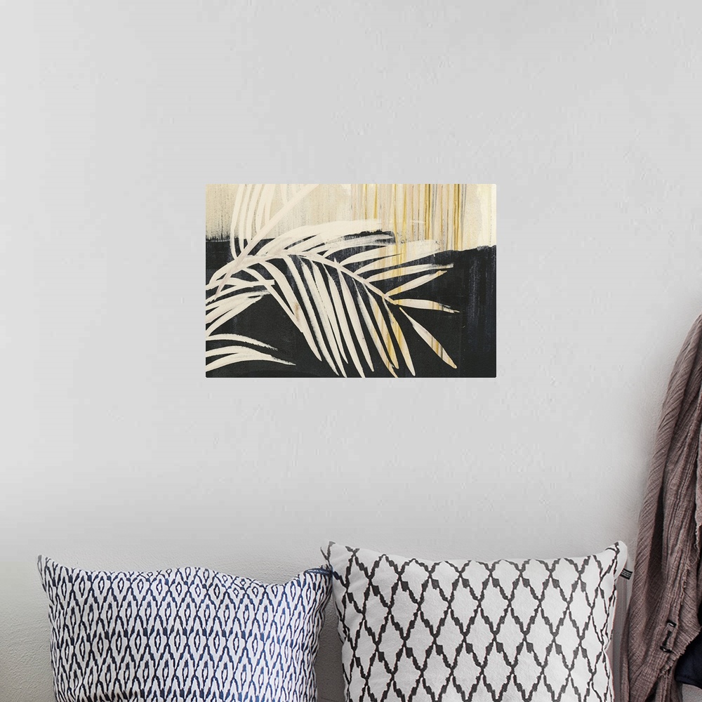 A bohemian room featuring Horizontal artwork of large palm leaves in beige tones with gold accents on black.