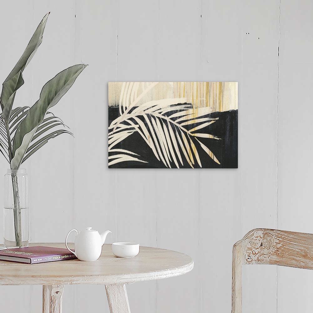 A farmhouse room featuring Horizontal artwork of large palm leaves in beige tones with gold accents on black.