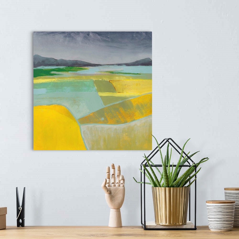 A bohemian room featuring Abstract landscape painting using vibrant yellow in the foreground of the image.